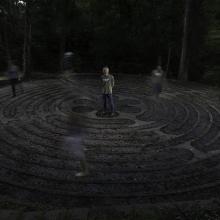 Army veteran Jay Waldo, co-creator of a veteran mental health program called Warriors' Ascent, stands in the middle of a labyrinth as others make their way through the maze. Photographed by Steve Gibson