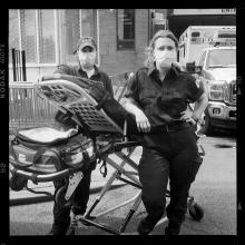 <a href='https://spencerartapps.ku.edu/collection-search#/object/62963' target='_blank'><i>Britt (left) and Kim (right) are EMTs with Hunter Ambulance based in the Bronx. They would bring Covid patients to Elmhurst Hospital in Queens</i> by Accra Shepp</a>