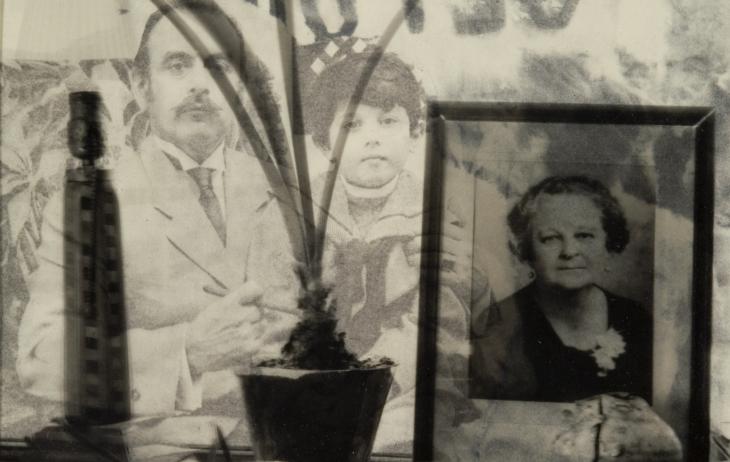 Transparency over xerox. Background is of a man holding a young boy who is wearing a sailor shirt. There is a photograph of an elderly woman in the right foreground, a potted plant in the center foreground, and a lamp in the left foreground.