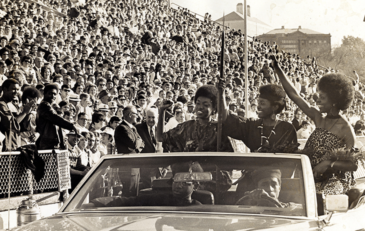Black Student Union Homecoming Queen candidates riding in car in football stadium, 1969