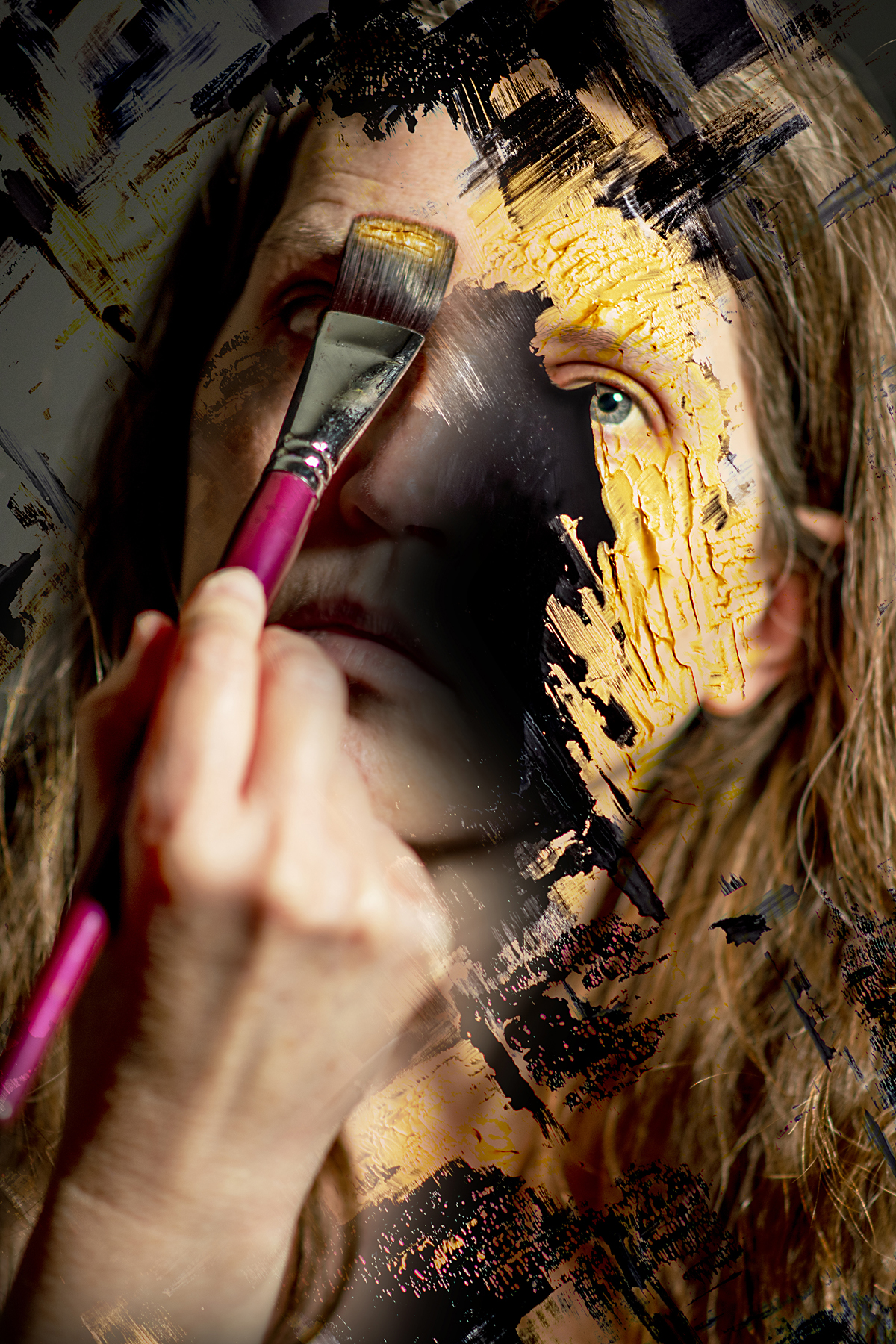 Portrait of a white person with long brown hair staring directly at the camera. The middle of their face is obscured by a black hole and a hand holding a paintbrush seems to add gold paint to their face.