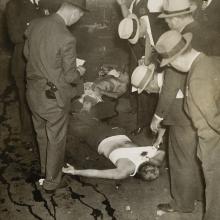 <a href="https://spencerartapps.ku.edu/collection-search#/object/16344" target="_blank"><i>"New York...The blood-spattered bodies of Joseph Amberg, and of Morris Kessler, alleged Brooklyn hoodlums, shown lying on the floor at a Brooklyn garage..."</i> by International News Photo</a>