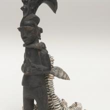 <a href="https://spencerartapps.ku.edu/collection-search#/object/35523" target="_blank"><i>Eshu figure with shell attachments</i> by Oyo peoples</a>
