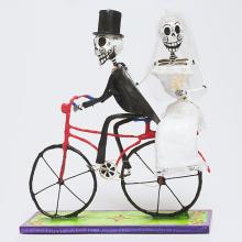 <a href="https://spencerartapps.ku.edu/collection-search#/object/38204" target="_blank"><i>bride and groom skeletons on a bicycle</i> by Mexico</a>