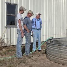 <a href="https://spencerartapps.ku.edu/collection-search#/object/58324" target="_blank"><i>Generations: Filling a stock tank—about six miles south of Greensburg, Kansas, October 2011</i> by Larry Schwarm</a>