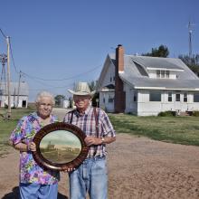 <a href="https://spencerartapps.ku.edu/collection-search#/object/58321" target="_blank"><i>Laurence and Pauline Schwarm in front of their 100-year old farm, Greensburg, Kansas, June 2011,</i> by Larry Schwarm,</a>