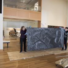 Artist Sandy Winters and Head of Collections Sofia Galarza Liu delicately transport a portion of Winters's mural-sized installation <i>Long Night's Journey into Day</i>