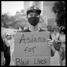 <a href='https://spencerartapps.ku.edu/collection-search#/object/62972' target='_blank'><i>Man showing intersectional support at an Occupy City Hall rally</i> by Accra Shepp</a>